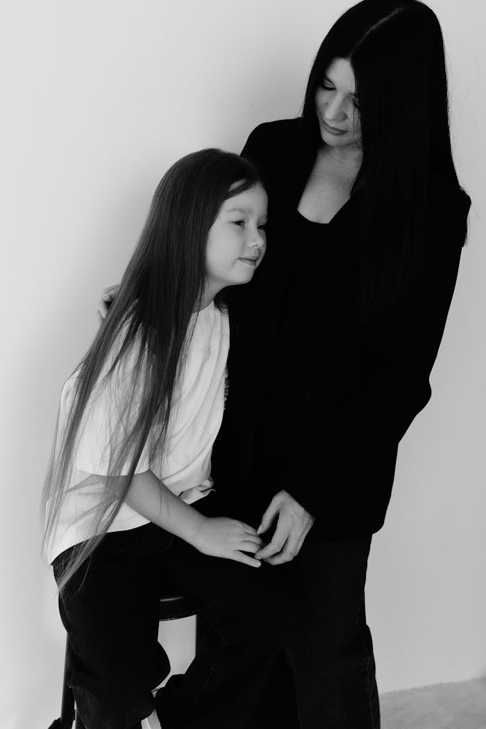 Tender black and white portrait of mother and daughter sharing a moment.